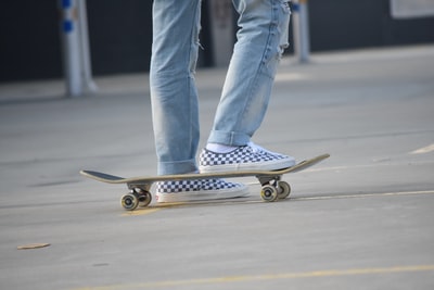 Wearing blue jeans and white sneakers on the slide
